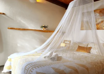 Double room with mosquito net canopy bed at Soul Spot Surf Camp, Praia Grande, Sintra