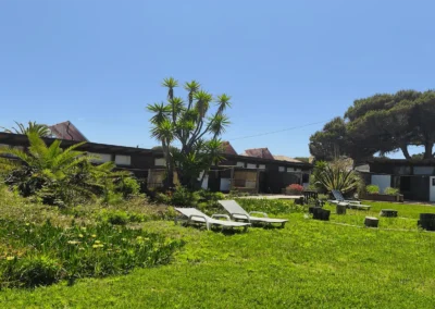 Garden lounge area with sun loungers at Soul Spot Surf Camp near Praia Grande, Sintra