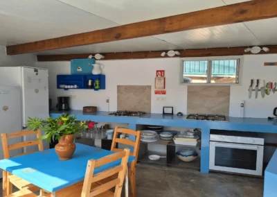 Communal kitchen and dining area at Soul Spot Surf Camp, Praia Grande, Sintra