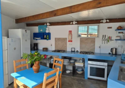 Communal kitchen and dining area at Soul Spot Surf Camp, Praia Grande, Sintra