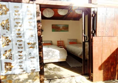 Twin room with paper lanterns and canopy beds at Soul Spot Surf Camp, Praia Grande